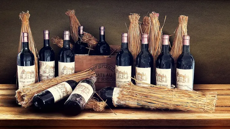 fine wine bottles staged with wheat stalks
