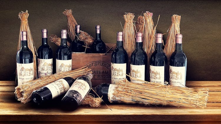 fine wine bottles staged with wheat stalks