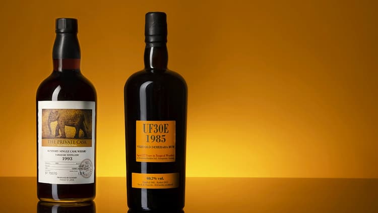 Two bottles of spirits with an amber background for the next Fine spirits Auction